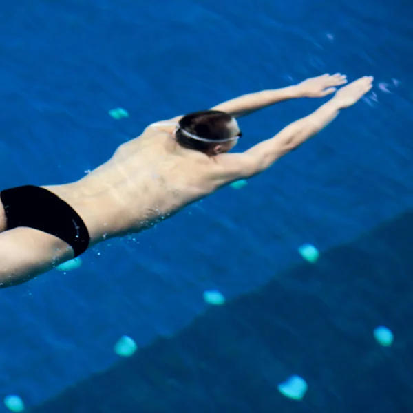 Άντρας κολυμβητής στην πισίνα. Υποθαλάσσια φωτογραφία — Φωτογραφία Αρχείου