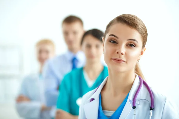 Attractive female doctor in front of medical group — Stock Photo, Image