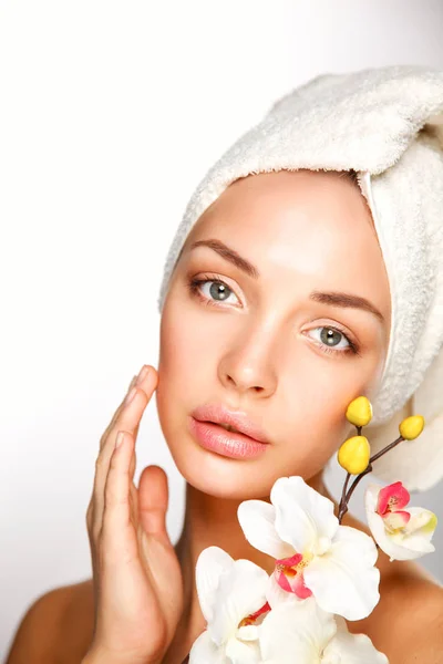 Portrait of beautiful girl touching face with a towel on her head — Stock Photo, Image