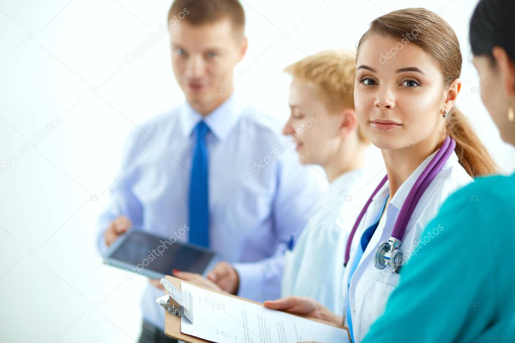 Attractive female doctor in front of medical group