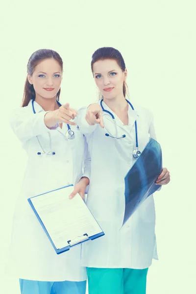 Two woman nurse watching X Ray image, standing in hospital, pointing you — Stock Photo, Image