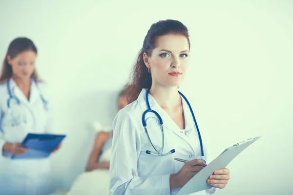 Woman doctor with folder standing at hospital — Stock Photo, Image