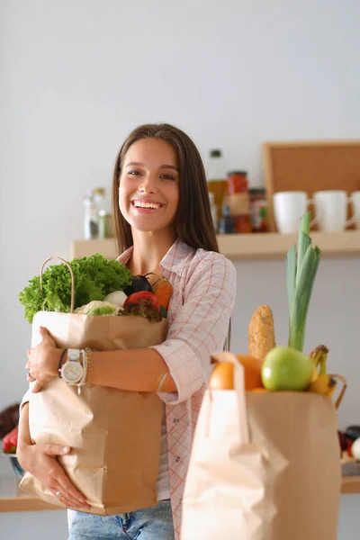 野菜と食料品の買い物袋を持っている若い女性 — ストック写真