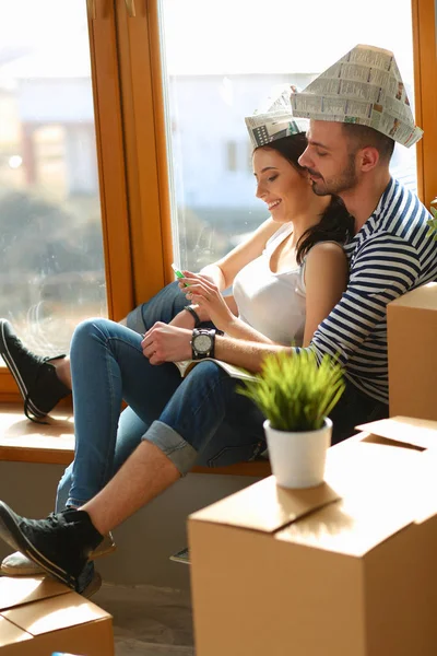 Couple moving in house sitting on the windowsill