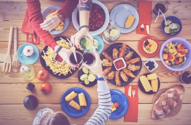 Yemek masasında içki içen insanlar.