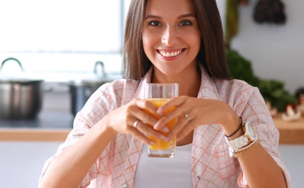 Young woman sitting a table  in the kitchen — Stock Photo, Image