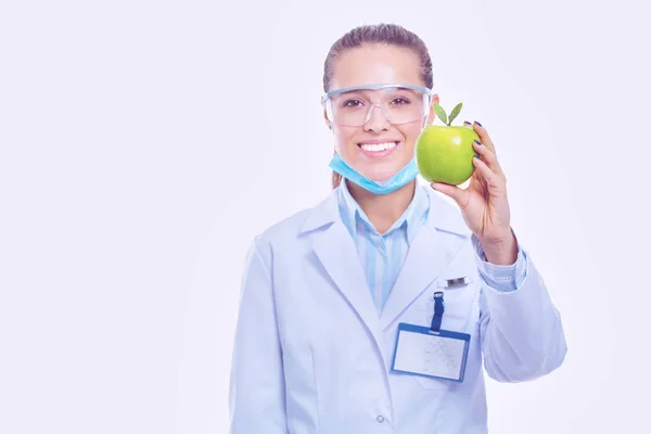 Mulher sorridente médico com uma maçã verde — Fotografia de Stock