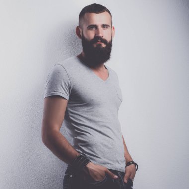 ayakta, gri arka plan üzerinde izole yakışıklı sakallı adam portresi