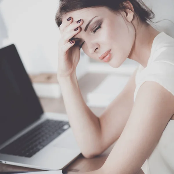 Portrait of tired young business woman with laptop computer at the office — Stock Photo, Image