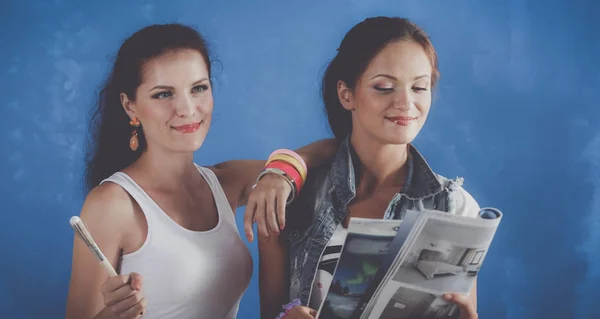 Dos hermosa joven mujer haciendo pintura de pared — Foto de Stock