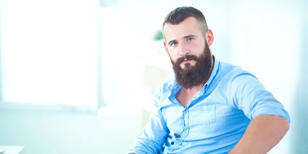 Young businessman sitting on chair in office — Stock Photo, Image