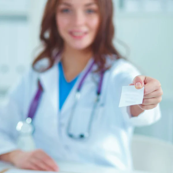 Kadın doktor elinde boş bir kart tutuyor, beyaz arka planda izole edilmiş. — Stok fotoğraf