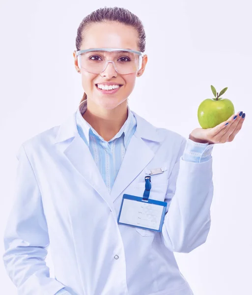 Sorridente medico donna con una mela verde — Foto Stock