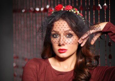 Saçında çiçekler olan güzel bir kadının portresi.