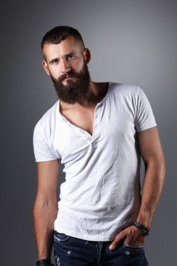 Ayakta, gri arka plan üzerinde izole yakışıklı adam portresi