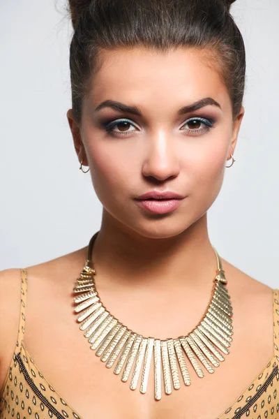 Young woman wearing a beige dress standing — Stock Photo, Image