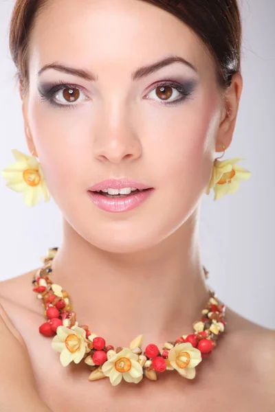 Portrait of young beautiful brunette woman in beads Stock Image
