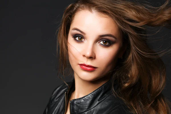 Portrait of beautiful brunette female wearing leather jacket — Stock Photo, Image