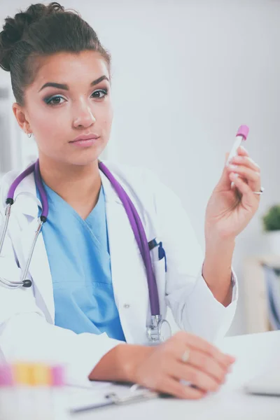 Woman researcher is surrounded by medical vials and flasks, isolated on white background — Stock Photo, Image