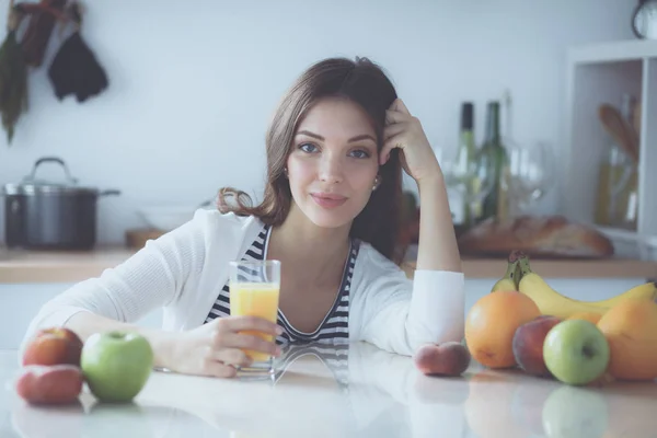 Portrait of a pretty woman holding glass with tasty juice — Stock Photo, Image