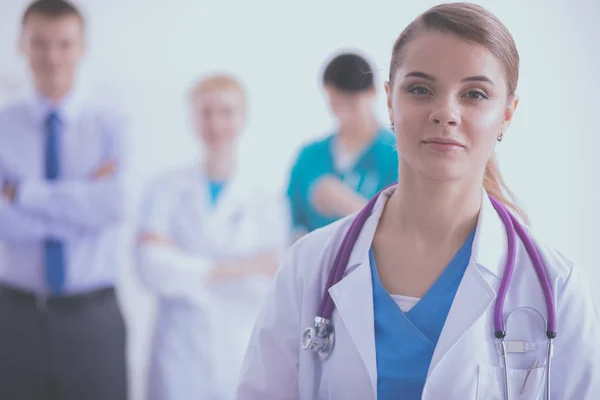 Attractive female doctor in front of medical group — Stock Photo, Image