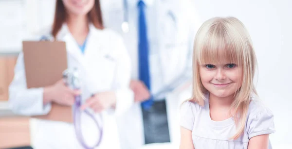 Female doctor examining child with stethoscope at surgery — Stock Photo, Image