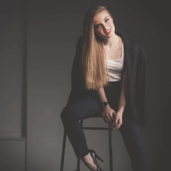 Young woman sitting on a chair — Stock Photo, Image