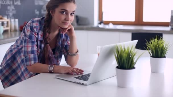 Beautiful woman cooking cake in kitchen standing near desk — Stock Video