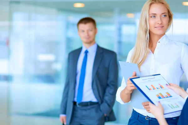 Portrait of young businesswoman in office with colleagues in the background — Stock Photo, Image