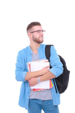 Okul çantası beyaz arka plan üzerinde izole kitap holding ile genç erkek öğrenci