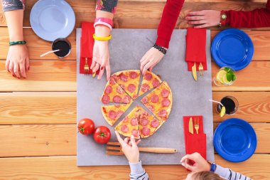 Bir grup insan masada oturan pizza yemek