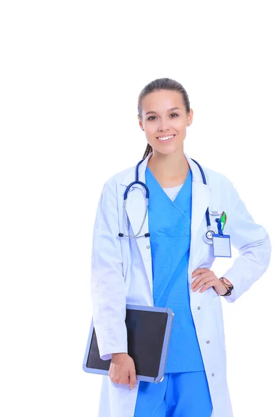 Young female doctor with clipboard standing on white background — Stock Photo, Image