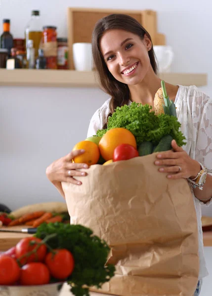 Jonge vrouw met grocery shopping bag met groenten en fruit — Stockfoto