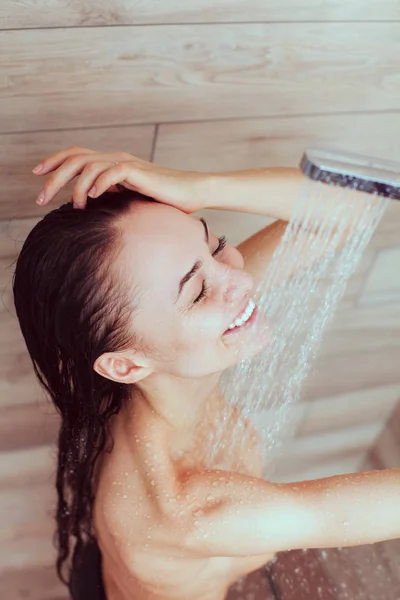 Joven mujer hermosa bajo la ducha en el baño — Foto de Stock