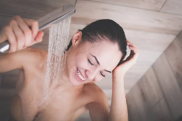 Jeune femme belle sous la douche dans la salle de bain — Photo