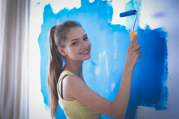 Hermosa joven haciendo pintura de pared, de pie — Foto de Stock