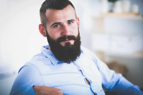 Jeune homme d'affaires assis sur une chaise dans le bureau — Photo