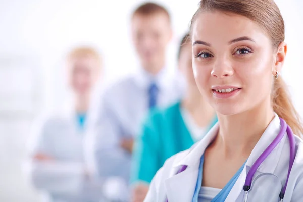 Attractive female doctor in front of medical group — Stock Photo, Image