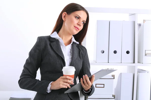 Business woman with a folder and paper cup of coffee — Stock Photo, Image