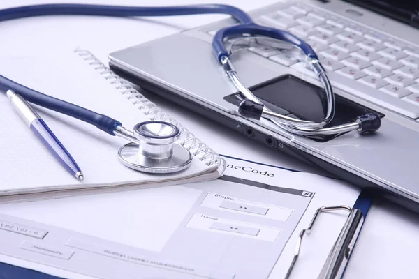 Estetoscopio médico, portátil, carpeta en el escritorio — Foto de Stock