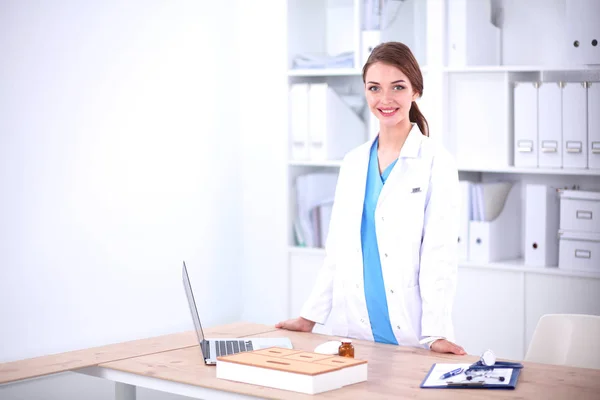 Portrait of young woman doctor with white coat standing in hospital — Stock Photo, Image