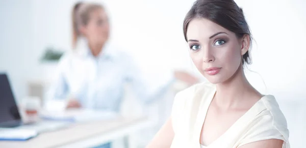 Attractive businesswoman sitting on desk in the office — Stock Photo, Image