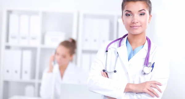 Portrait of young woman doctor with white coat standing in hospital — Stock Photo, Image