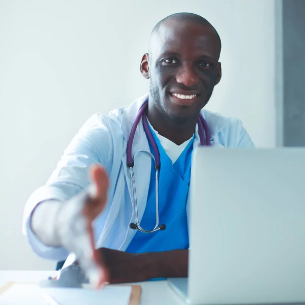 Male doctor handshake at his patient in medical office