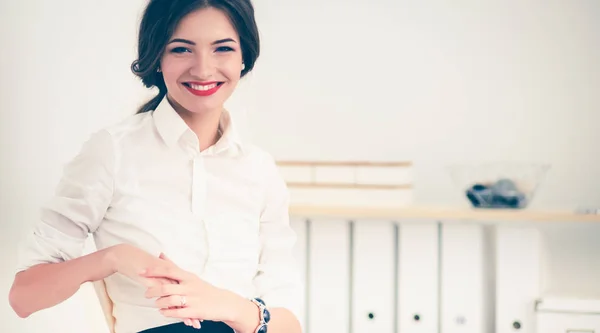 Attractive businesswoman sitting  in the office — Stock Photo, Image