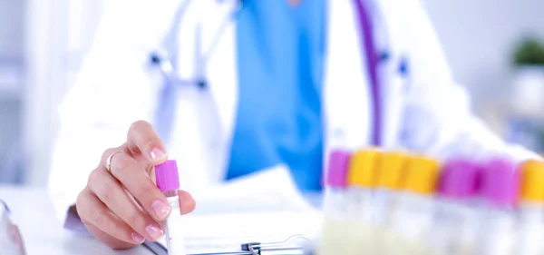 Woman researcher is surrounded by medical vials and flasks, isolated on white background — Stock Photo, Image