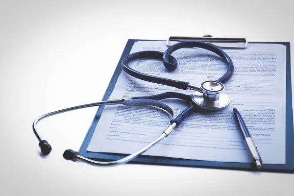 Close up of doctors medical stethoscope and patient medical information — Stock Photo, Image