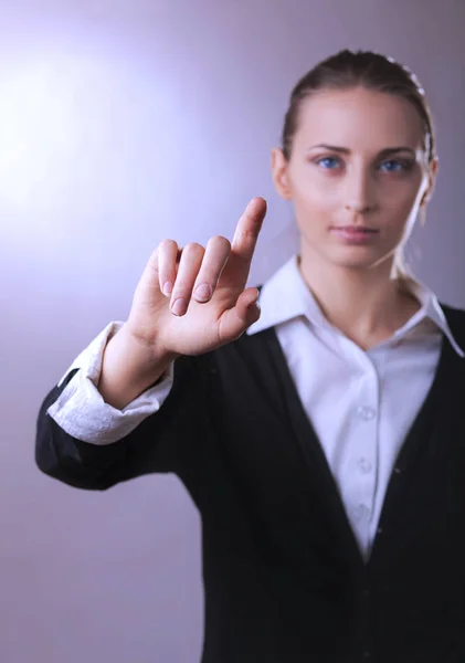 Business woman pointing finger. Isolated on gay background — Stock Photo, Image
