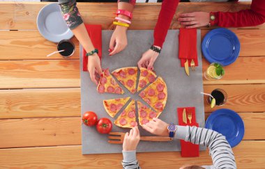 Birlikte yemek yiyen bir grup insanın üst düzey görüntüsü.