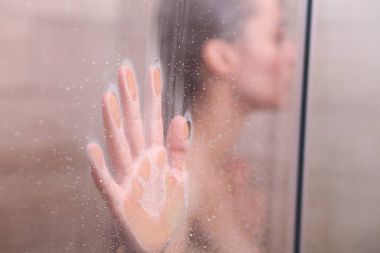 Genç beautyful kadın banyoda duş altında.